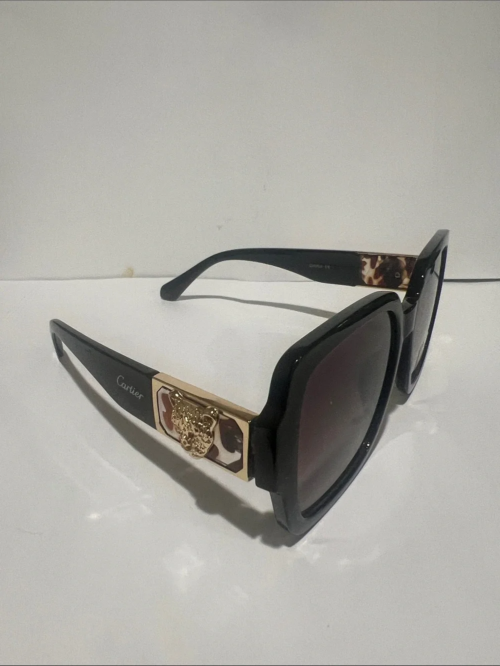 Cartier Women's Black Frame Sunglasses with Brown Gradient Lenses
